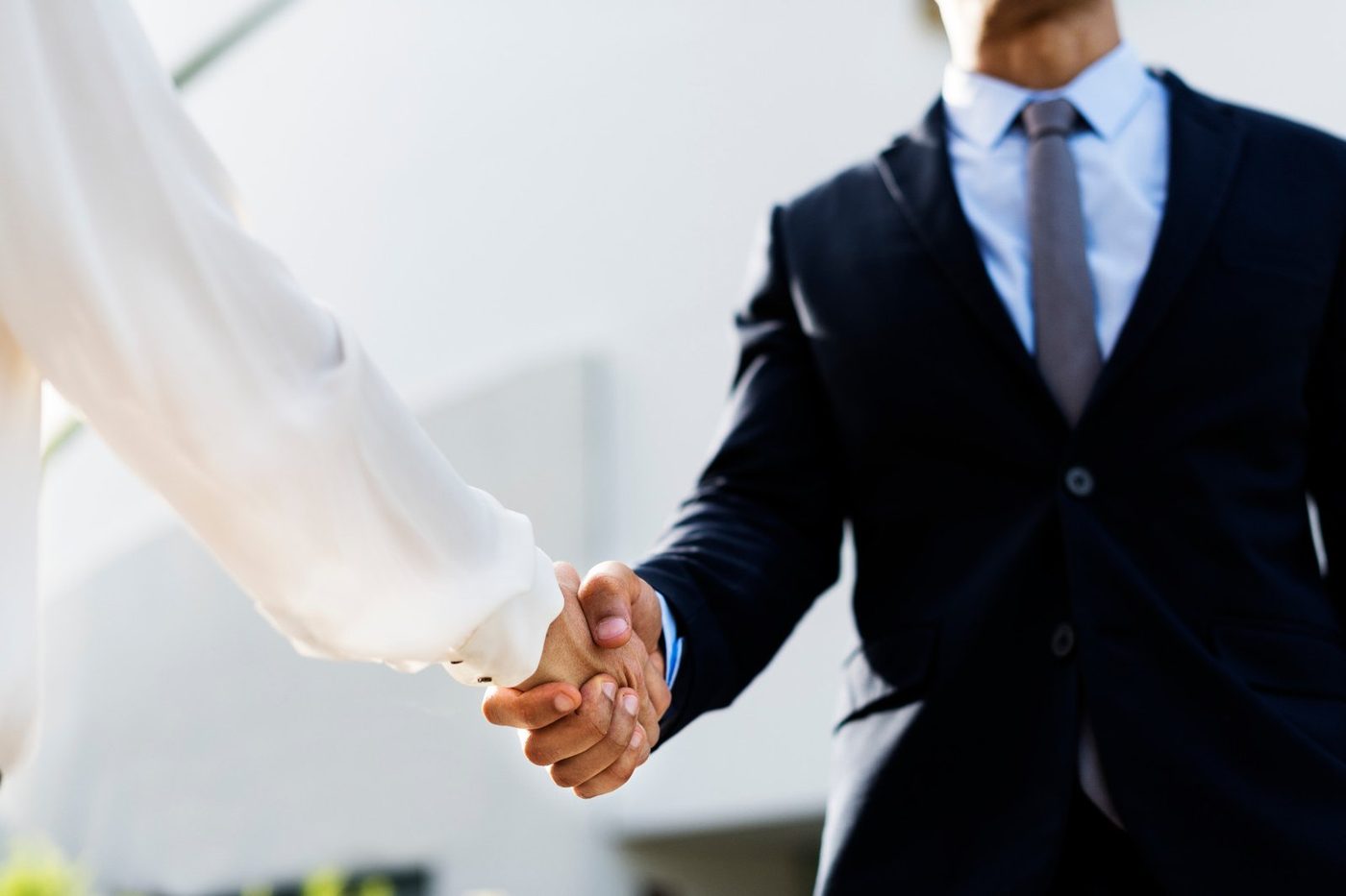Business partners shaking hands after agreeing supply terms